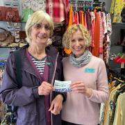 The raffle winner, Rita Bullock (left) and St Richard's Hospice Upton shop manager Clare Griffiths (left) pictured with the winning ticket