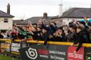 The travelling Hereford fans celebrate their side’s 2-1 victory at Southport