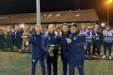 Worcester City management team celebrate with the trophy