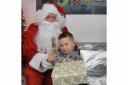 FESTIVE VISITOR: Father Christmas with Brody Martin, aged 3.