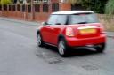 REPAIRS: A car drives past a pothole on Northwick Road, Worcester