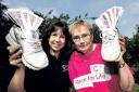 pay in sponsorship: Janet Burley, right, from West Malvern raised £1,050 for Cancer Research at Race for Life on June 16. She hands over her donation to Paula Young, Cancer Research press officer. Picture John Anyon. 3513391701