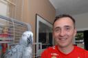 England supporter Fran Sheridan with his African Grey parrot Slipmatt who can sing the theme tune from The Great Escape. He can also say England! and Come on Rooney! Picture by Nick Toogood 2514626104.