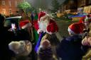 Father Christmas handing out presents in Victoria Street, Barbourne, at the neighbours' Christmas lights switch on.