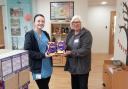 An employee from Doncasters Precision Castings Deritend, exchanging chocolate eggs to Acorns Children's Hospice.