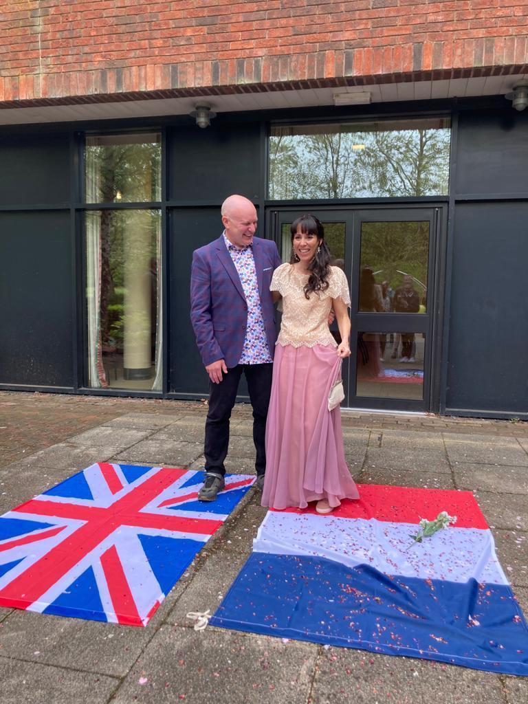 The couple stood on flags from their home countries after the ceremony at County Hall