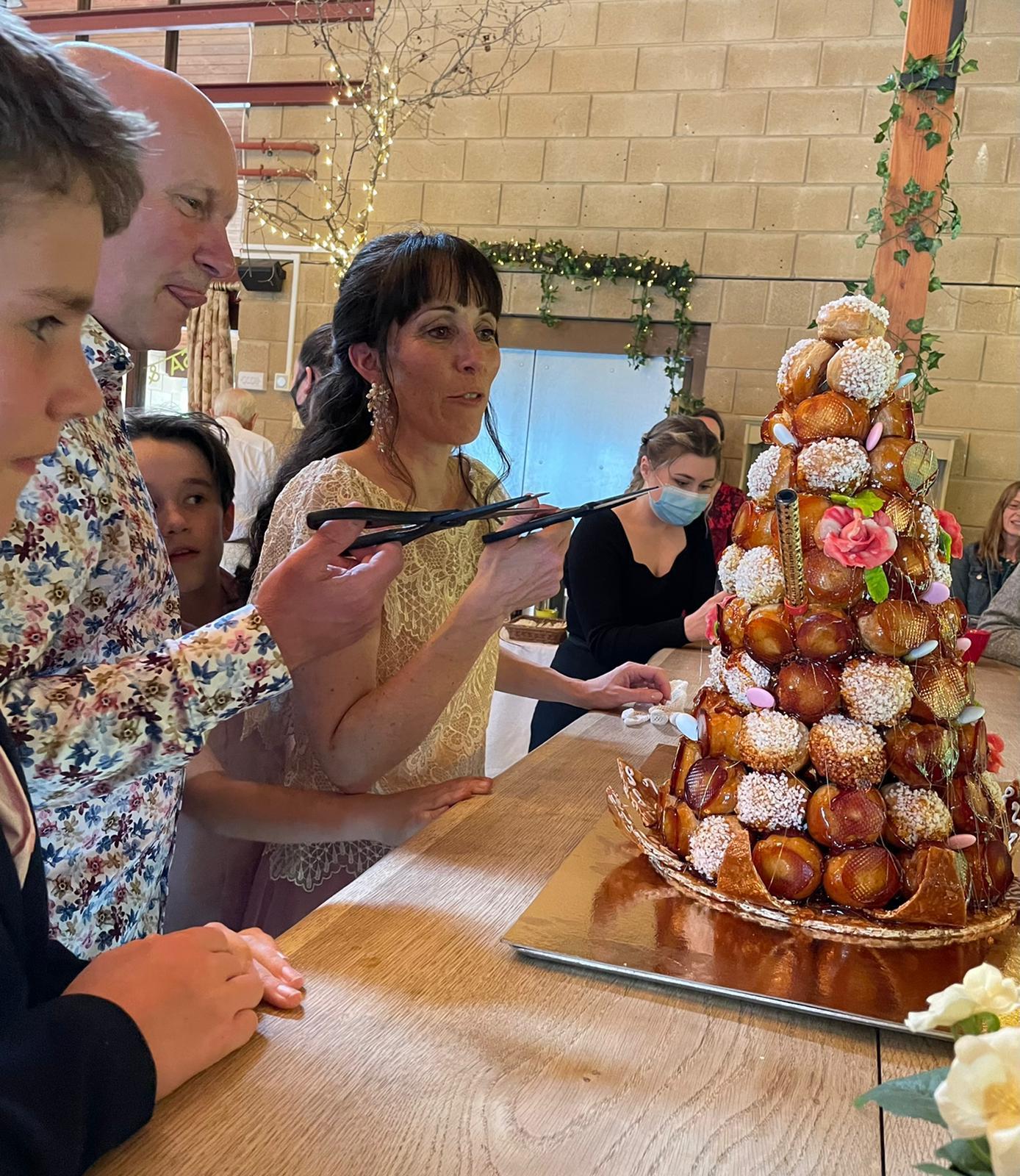 The couple cut the traditional French wedding cake, known as a Croquembouche