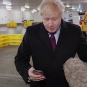 Screen grab from ITV of Prime Minister Boris Johnson looking at a photograph of a four-year-old boy with suspected pneumonia having to sleep on the floor in a hospital because of a shortage of beds, on the phone of ITV reporter Joe Pike, after initially