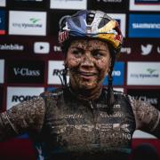 MUDDY DELIGHT: Evie Richards warms up for Tokyo Olympic Games with third placed finish in World Cup ride in Les Gets. Pic: Ross Bell