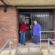DIFFICULTY: Jill Desayrah (left) and Lesley Myatt, Wheelchairs and mobility scooters could not easily get through this communal door in Sheepscombe Drive