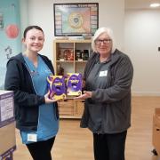 An employee from Doncasters Precision Castings Deritend, exchanging chocolate eggs to Acorns Children's Hospice.