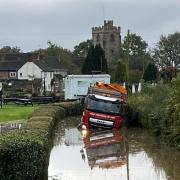 STUCK: The lorry is submerged in flood water on Church Lane in Severn Stoke.