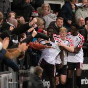 Lassana Mendes celebrates his 56th minute equaliser with the Hereford fans