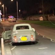 SCENE: The Nissan Figaro involved in the incident which left a woman in her 40s with 'life-threatening injuries' in Windermere Drive in Blackpole