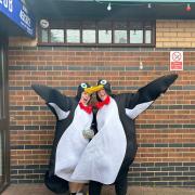 Wishing Well Nurseries staff Jess Baylis and Laura Warden dressed as penguins and selling raffle tickets.