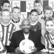 PLANS: Former footballer Cyrille Regis at Worcester’s St George’s Lane with some of the boys who will be playing in the new Midland Junior Premier League