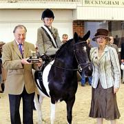 AWARD: Jessica Thomas, aged 11, is presented with one of her four trophies she picked up at the national side saddle championships. Picture courtesy of emmpix.co.uk.
