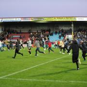 INVASION: Fans run onto the pitch after City’s FA Cup second round match at Scunthorpe United.