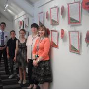 TRIBUTE: James Robertson (Warndon Library), Thomas, 13 years old, and Isobel, 12 years old, pupils at Pershore High School, Naomi Flannagan (librarian, Pershore High school) and Emma Powell (Pershore library manager) with the display at Pershore Library