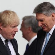 FIASCO: 'Please stop saying silly things!' Boris Johnson talking to Chancellor Philip Hammond.