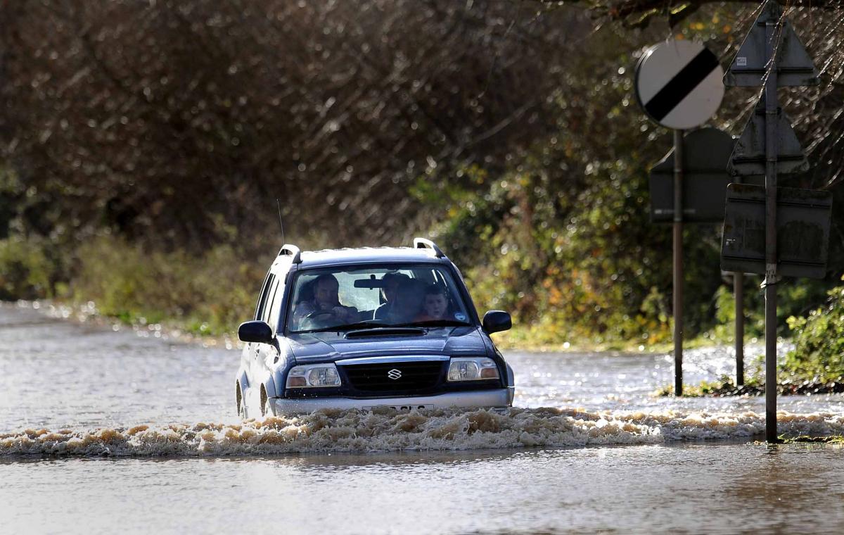 A car battling through flood water in Fladbury.