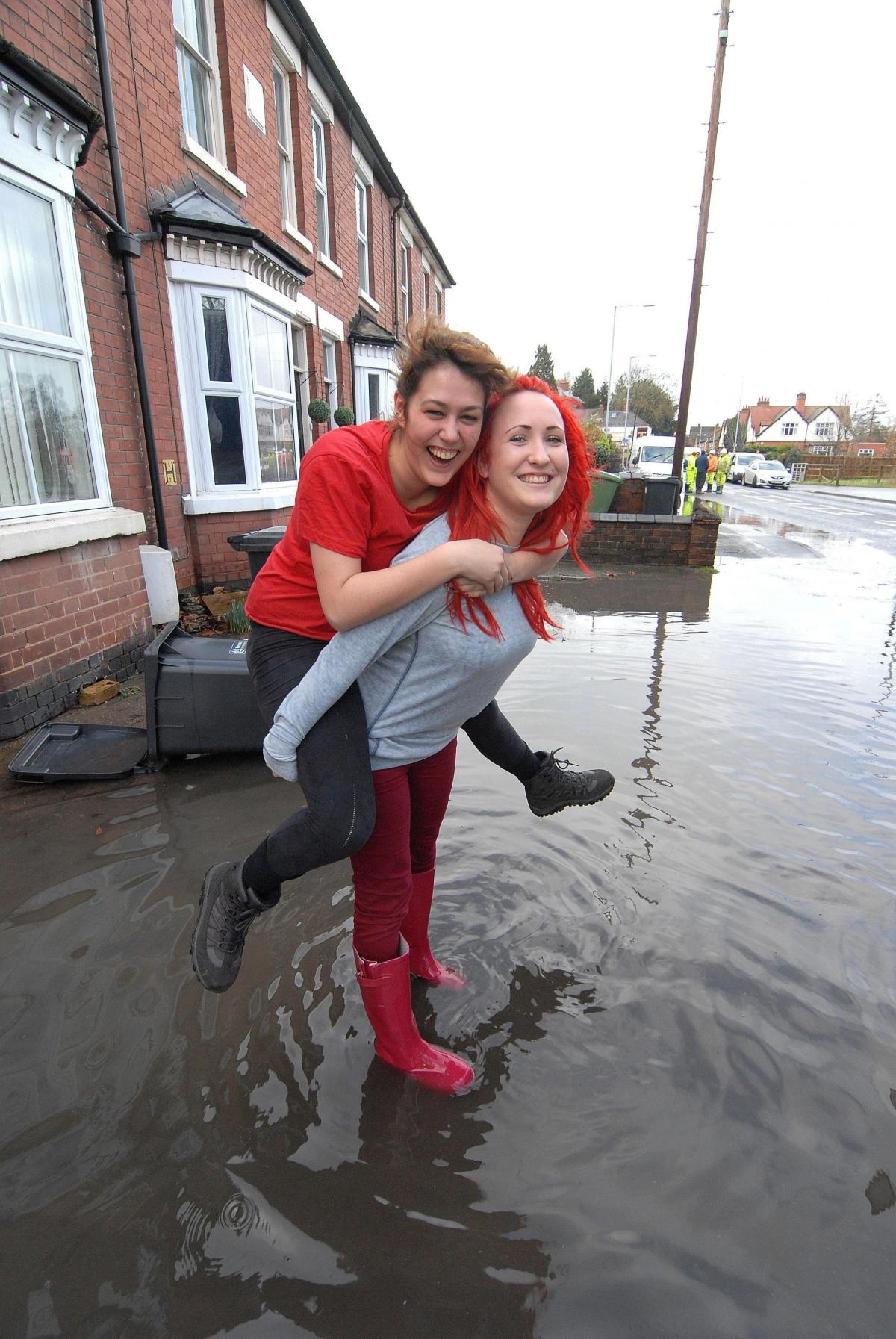  Students Vicky Potts and Claire Wearing are in good spirits despite the flooding on Hylton Road in Worcester. 0714520303