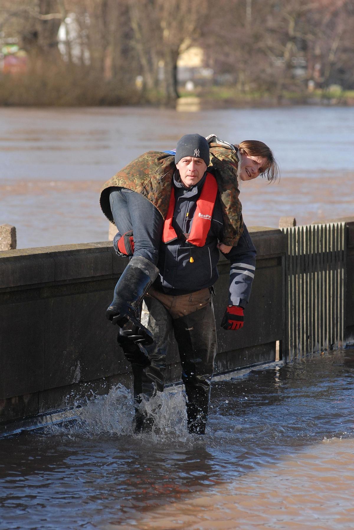  A man carries a woman through the flood water on North Parade.0714520549
