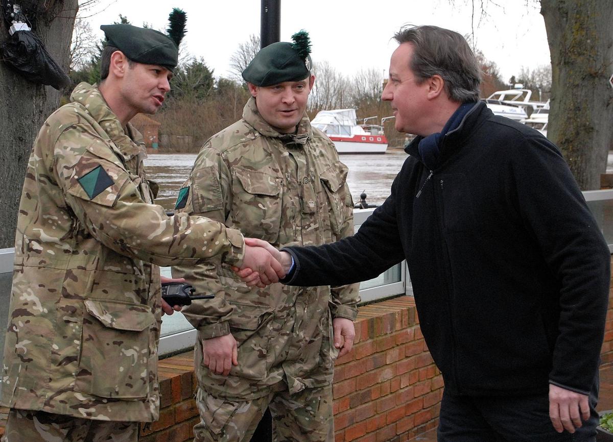 Upton-upon-Severn Prime Minister David Cameron visits Upton. Meeting troops, from left -  lance cooporal Pearse Murphy, colour sargeant Neil Horner and major Darren McCleery.0814523207