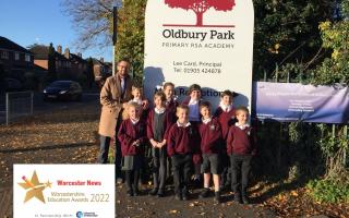 Headteacher Lee Card with some of the pupils outside Oldbury Park Primary School