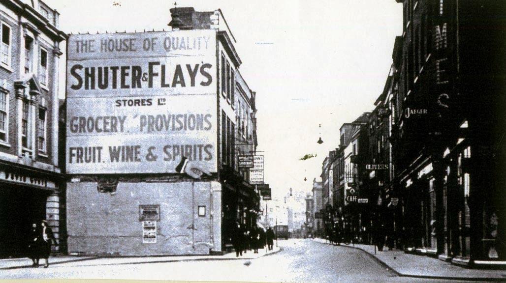 the Shuter and Flays shop sign, which was at the north-facing end of a row of shops pulled down in the 1920s and 1930s