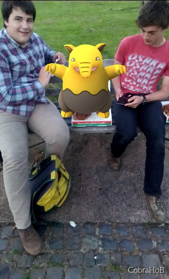 A Drowzee sits between two Pokemon GO players in Worcester