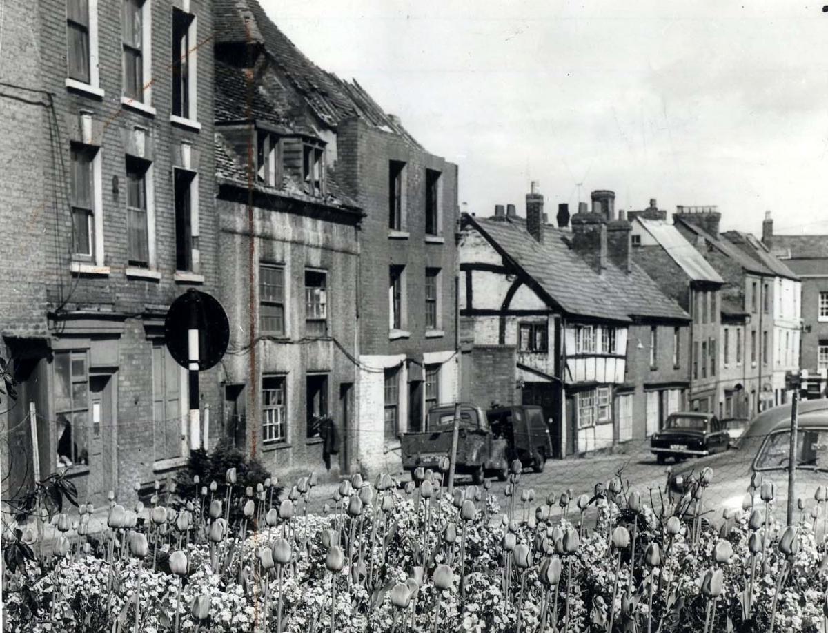 Vanished Worcester. A bed of tulips tries unsuccessfully to maks the sorry state of Lich Street, Worcester, which was undergoing partial demolition in 1954