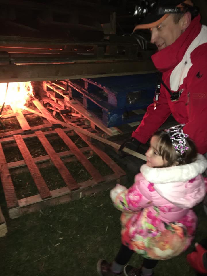 Georgie Gibbs lights the bonfire with Martin Darke, of Temple Fireworks, at Pitchcroft. Picture by Clare Gibbs.