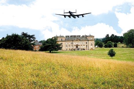 Lancaster Bomber caught flying over historic house