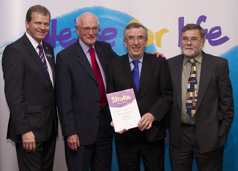 Charlie Hodges (in the centre) receiving a Life After Stroke certificate for his fund-raising efforts in 2014