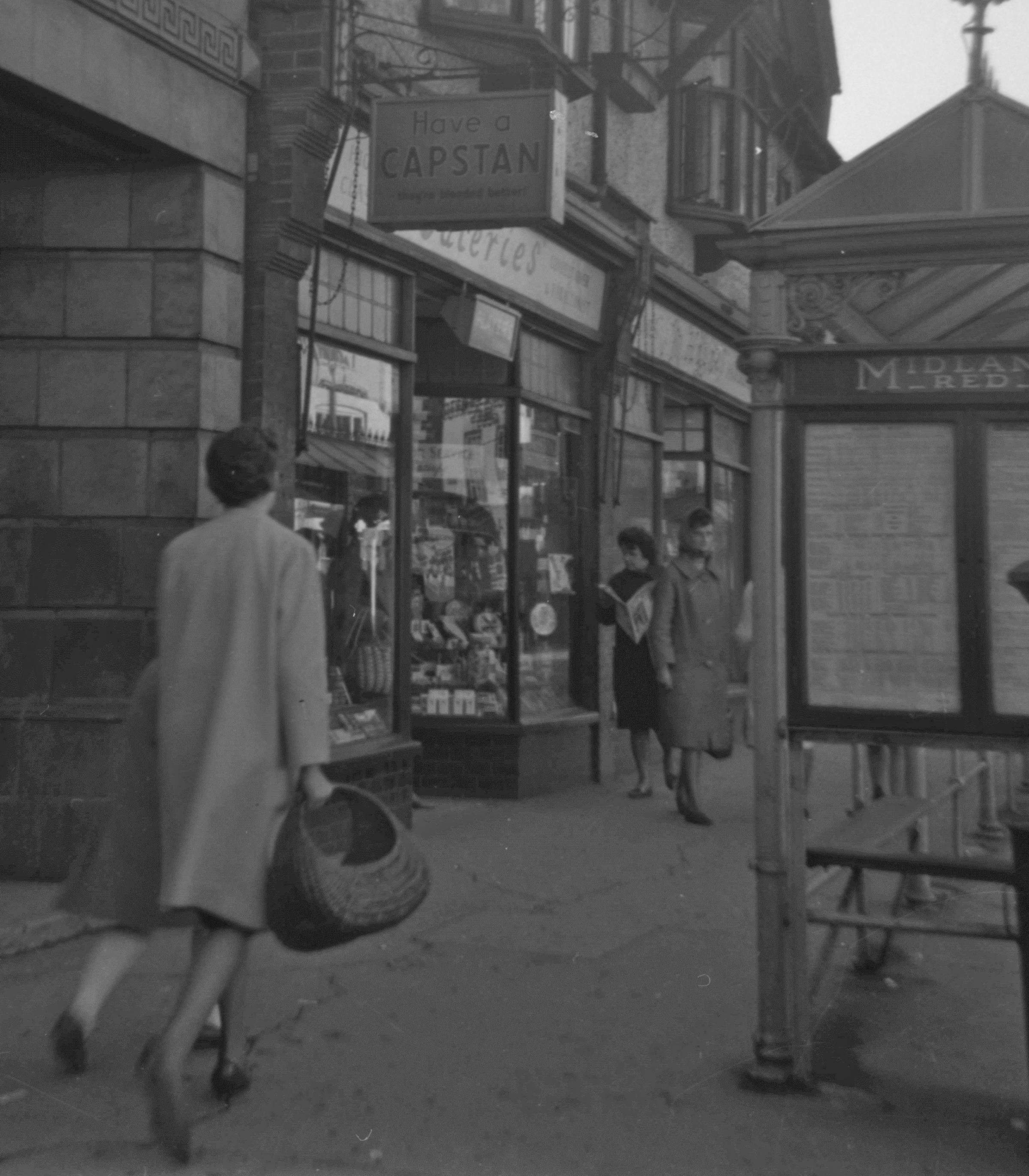 Angel Place in the early 1950s, this lady is heading into town, shopping basket in hand 