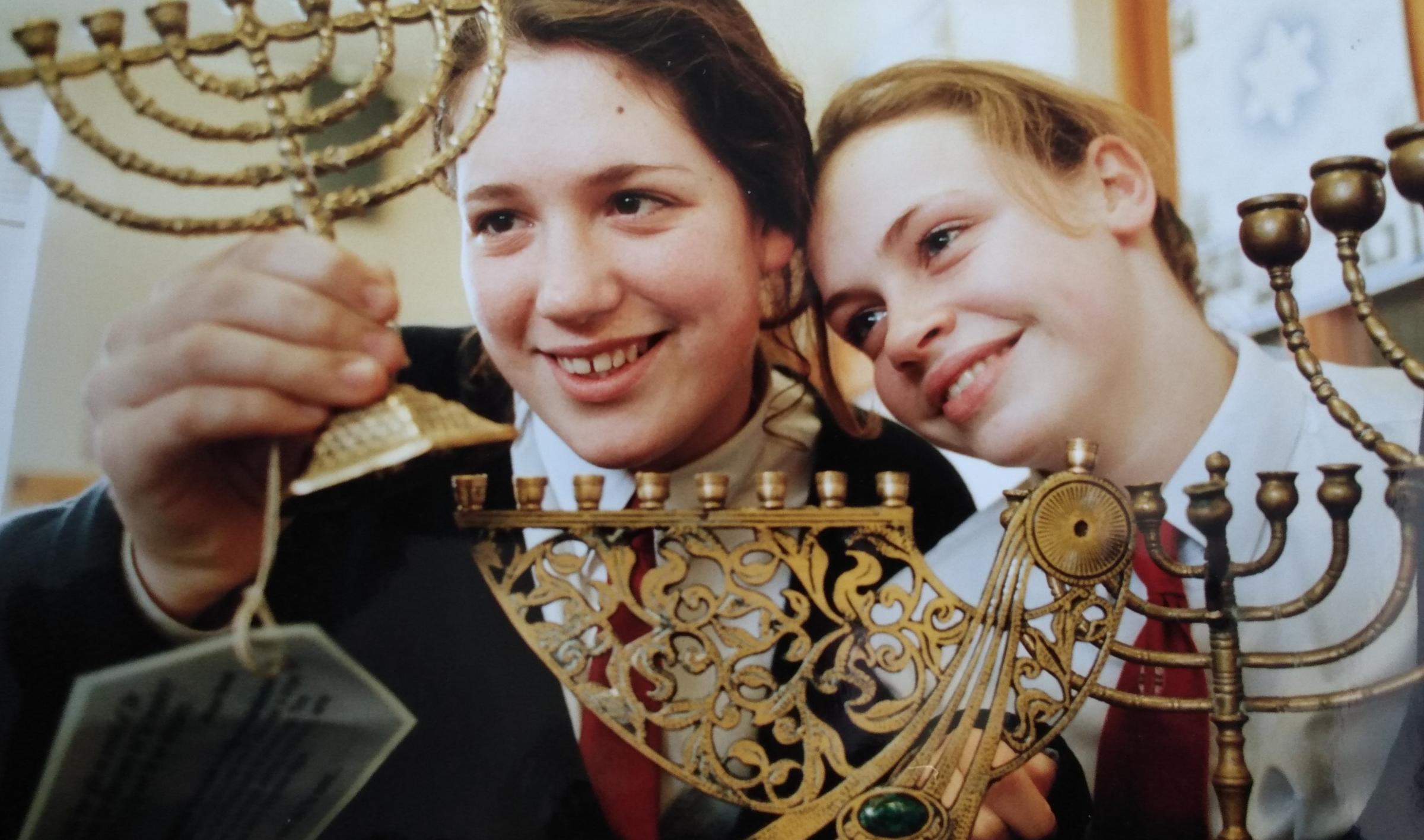 January 1994 and Penny Neville-Lee, left, and Kristy Askew are pictured with a set of chanukha lamps at an exhibition of Jewish life at the school