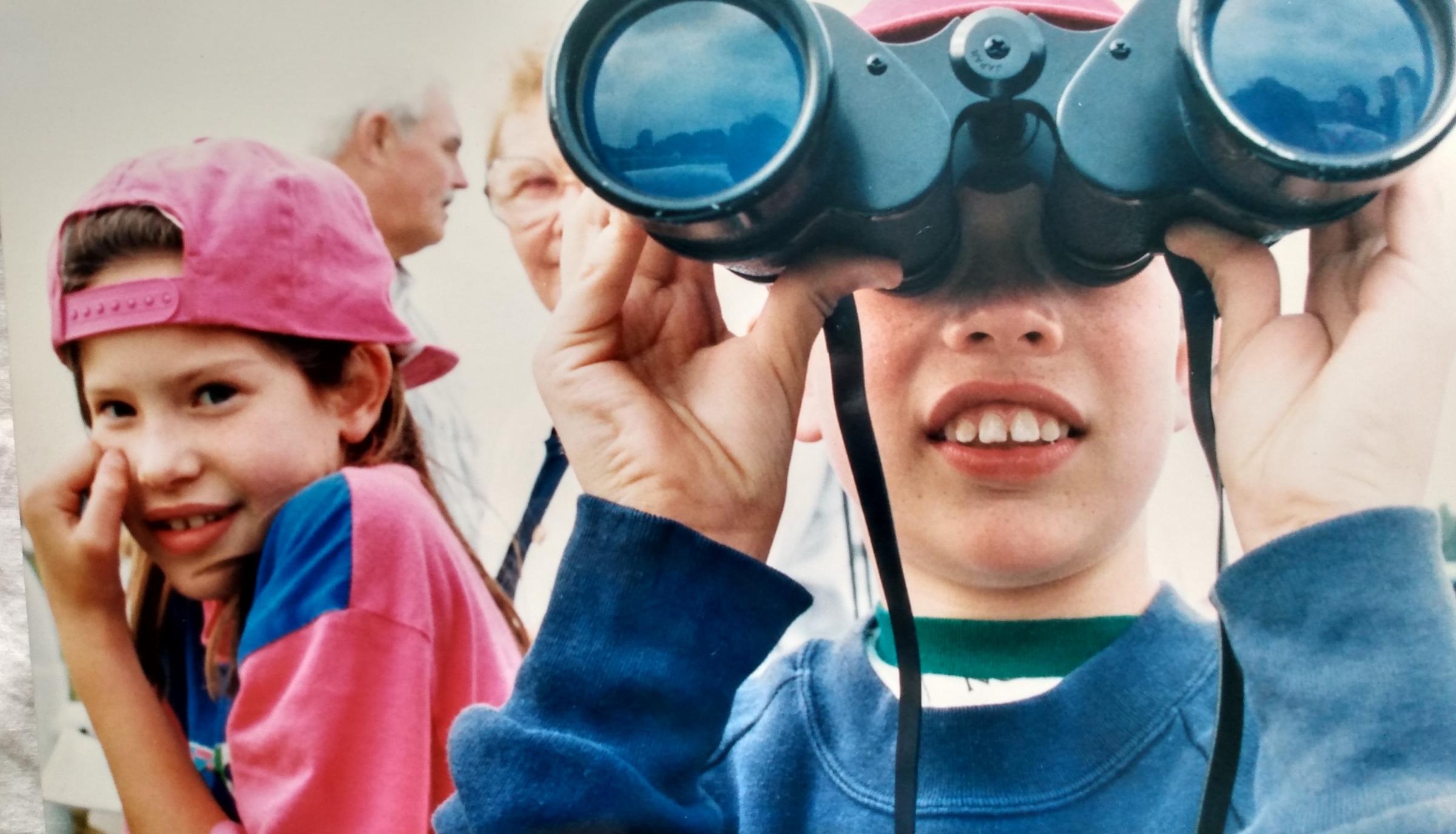 Felicity and James Coll, with binoculars, studying the action from afar in August 1994