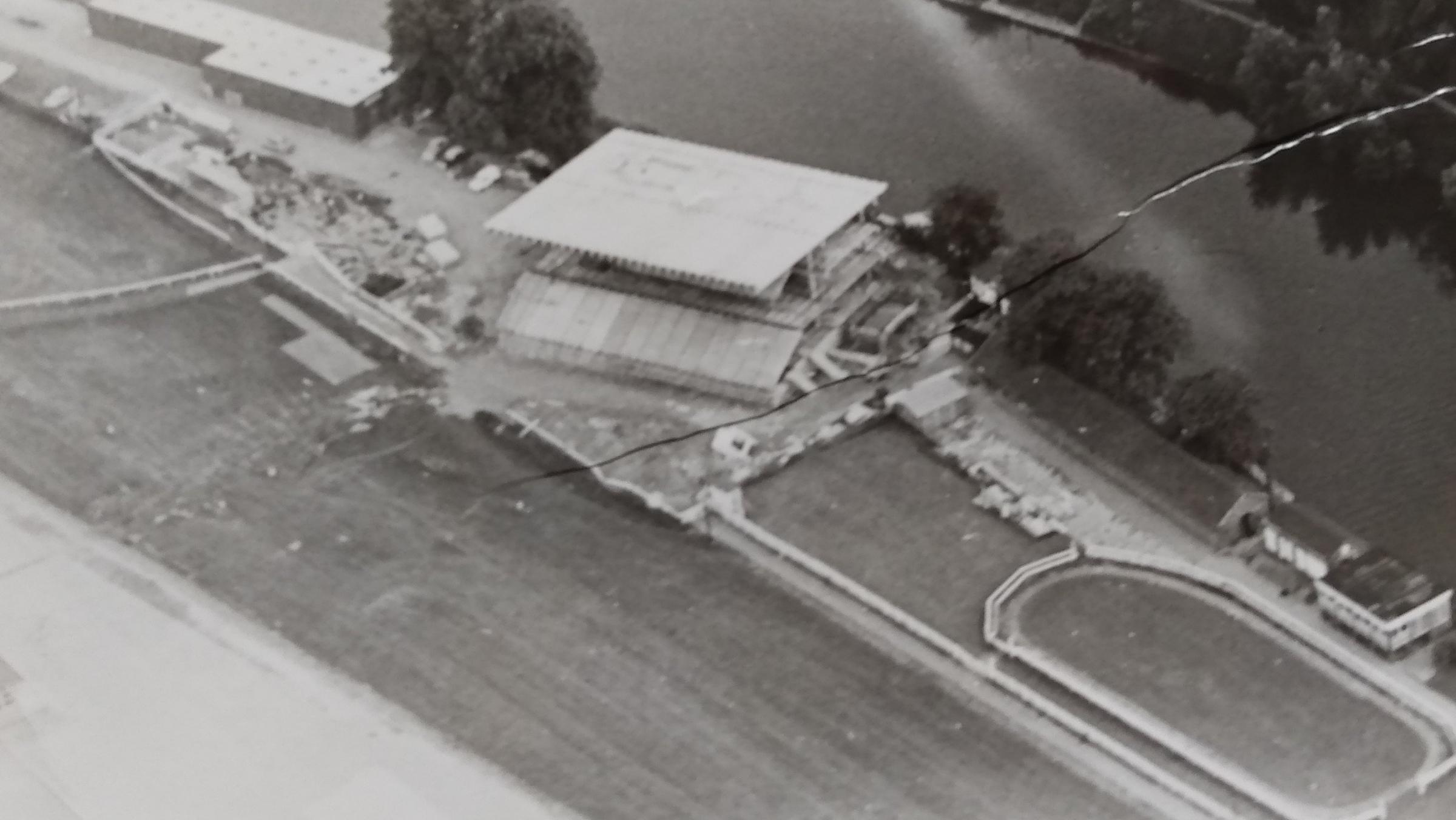 An aerial views of the grandstand construction in August 1974. And no, it’s not a bridge, it’s a crease in the image