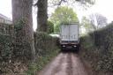 A Next lorry has to reverse out of the narrow lane, which residents and councillors want closed to vehicles