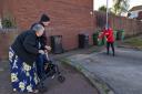 DANGER: Hazel Gilbert who is disabled struggles to get over the kerb if cars park over the dropped kerb in Potters Close - pictured here with her husband Eddie and Cllr Jill Desayrah