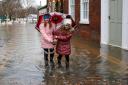 Children take a walk in a soggy South Quay in Worcester