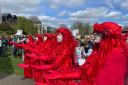 Members of the Red Rebel Brigade at the protest against raw sewage pollution into rivers at Victoria Park, Newbury on Sunday, April 14. Credit: John Sutton, Clearwater Photography