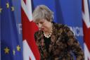 British Prime Minister Theresa May walks by the Union Flag and EU flag as she departs a media conference at an EU summit in Brussels, Friday, Dec. 14, 2018. European Union leaders expressed deep doubts Friday that British Prime Minister Theresa May can li