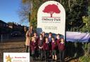 Headteacher Lee Card with some of the pupils outside Oldbury Park Primary School