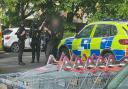 POLICE: An eyewitness captured this image of police holding a sword at Sainsbury's Blackpole.