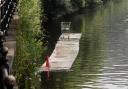 STRANGE: A pontoon with a traffic cone and a shopping trolley has been pictured floating down the River Severn.