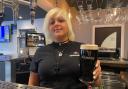 Feathers general manager Jade Colquitt with a £2 pint of Guinness