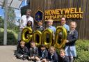 CELEBRATE:  Honeywell Primary School headteacher Andrew Morley with pupils celebrating a 'good' rating from inspectors Ofsted