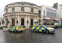 Police cars block the entrance to Church Street in Malvern after the incident